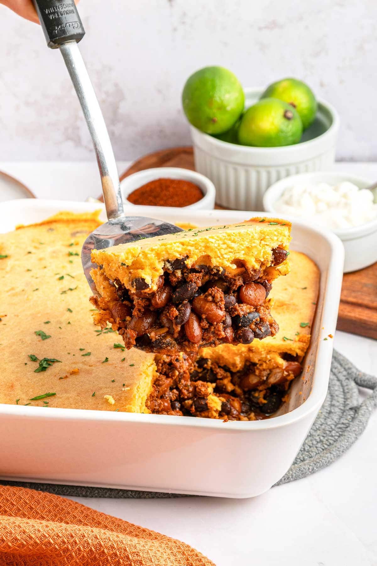 Chili Cornbread Casserole serving lifted out of dish.