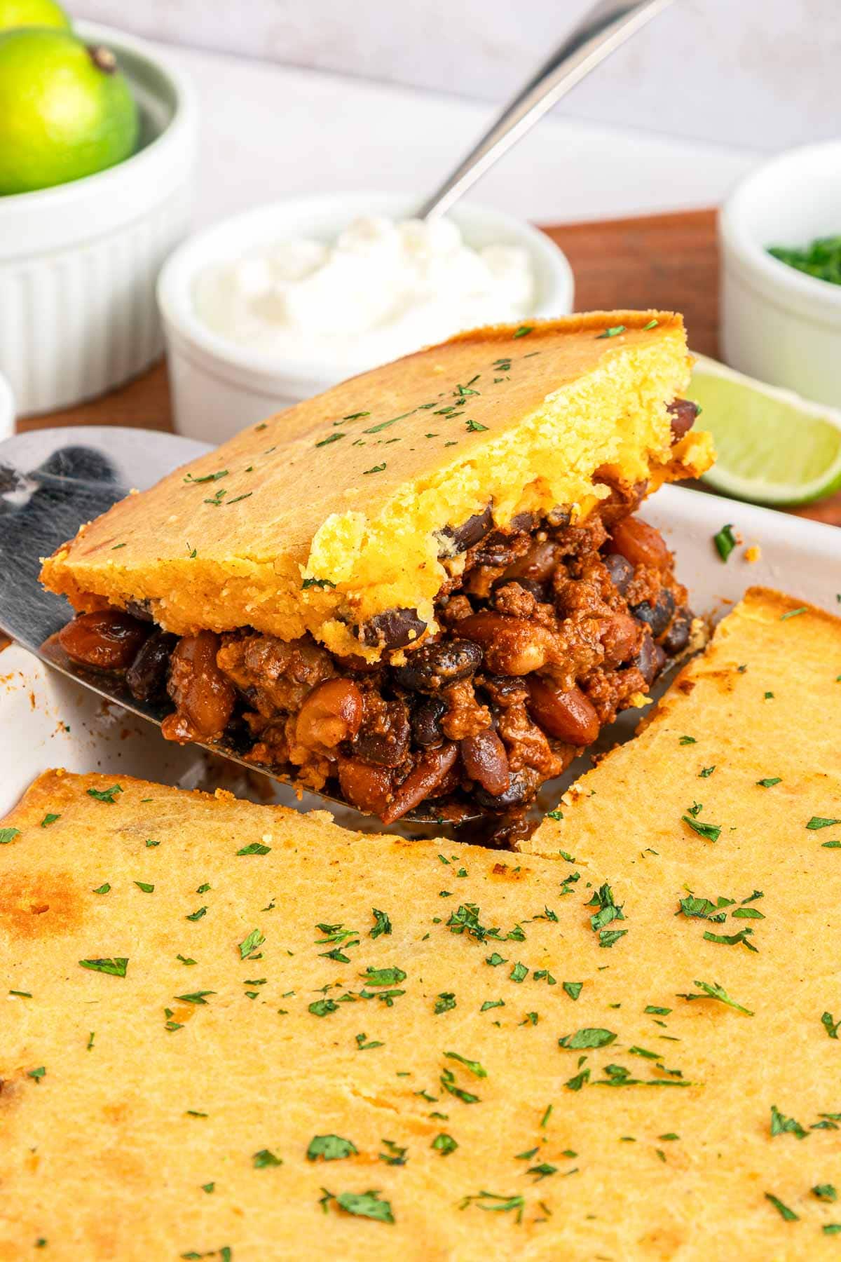 Chili Cornbread Casserole serving on metal spatula.