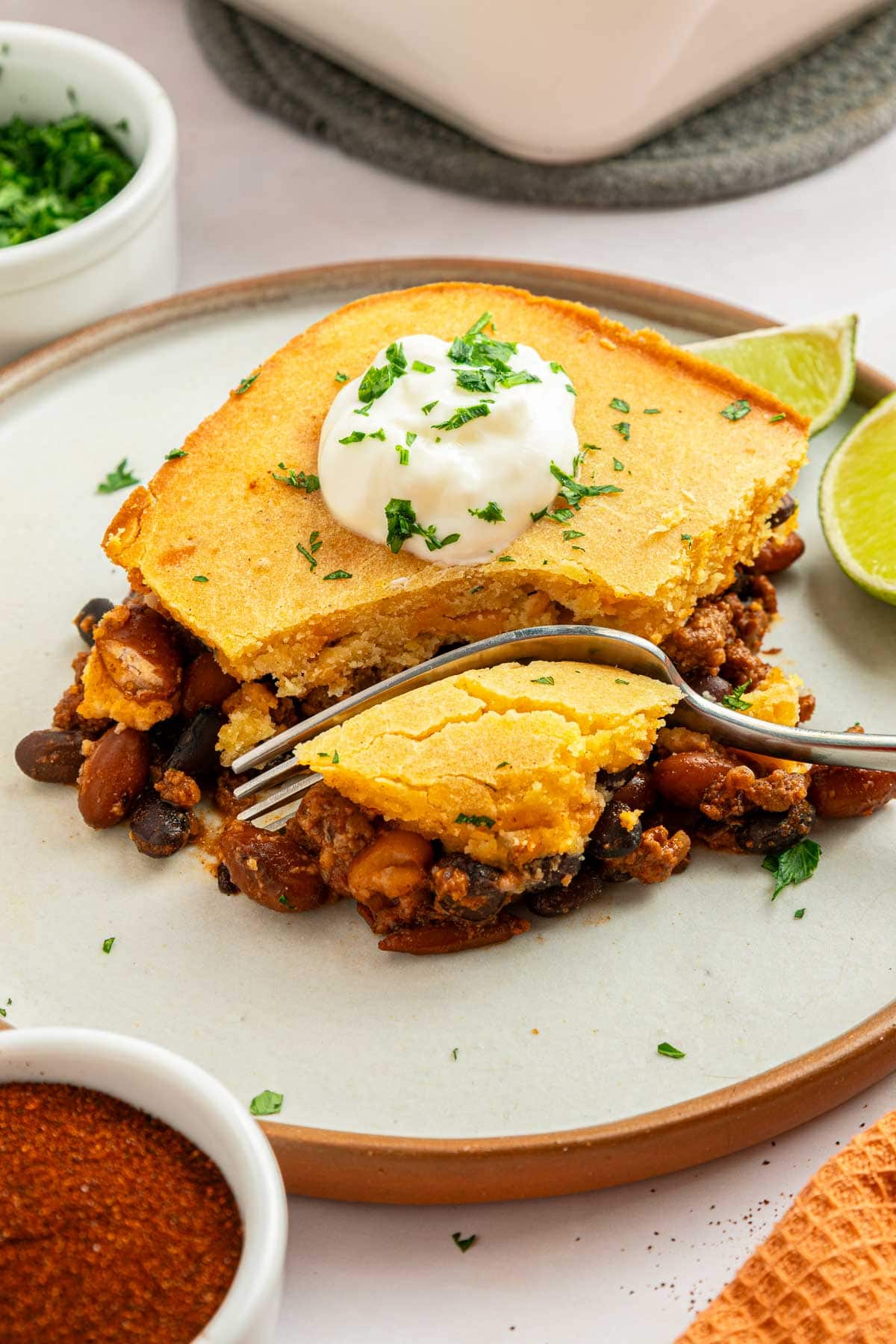 Chili Cornbread Casserole being cut by fork.