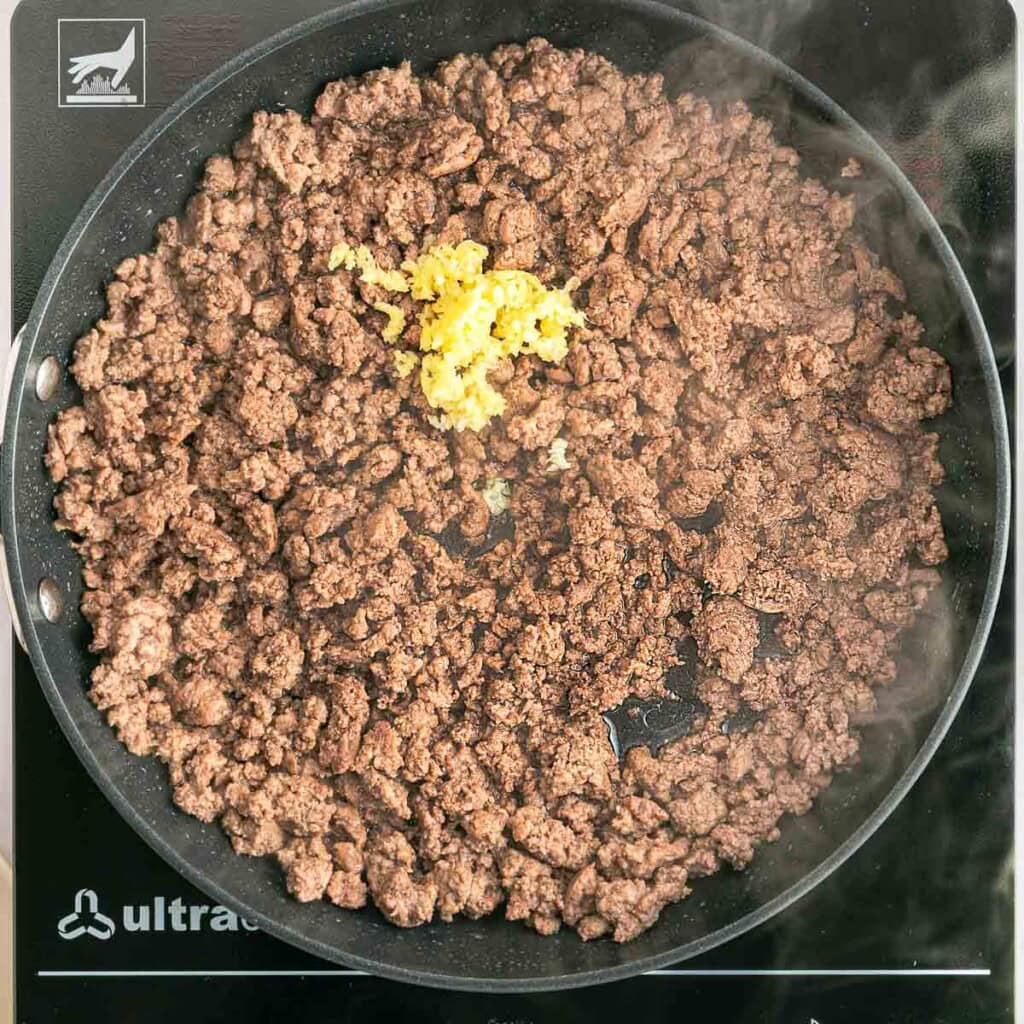 Browned ground beef with garlic for Chili and Cornbread Casserole.