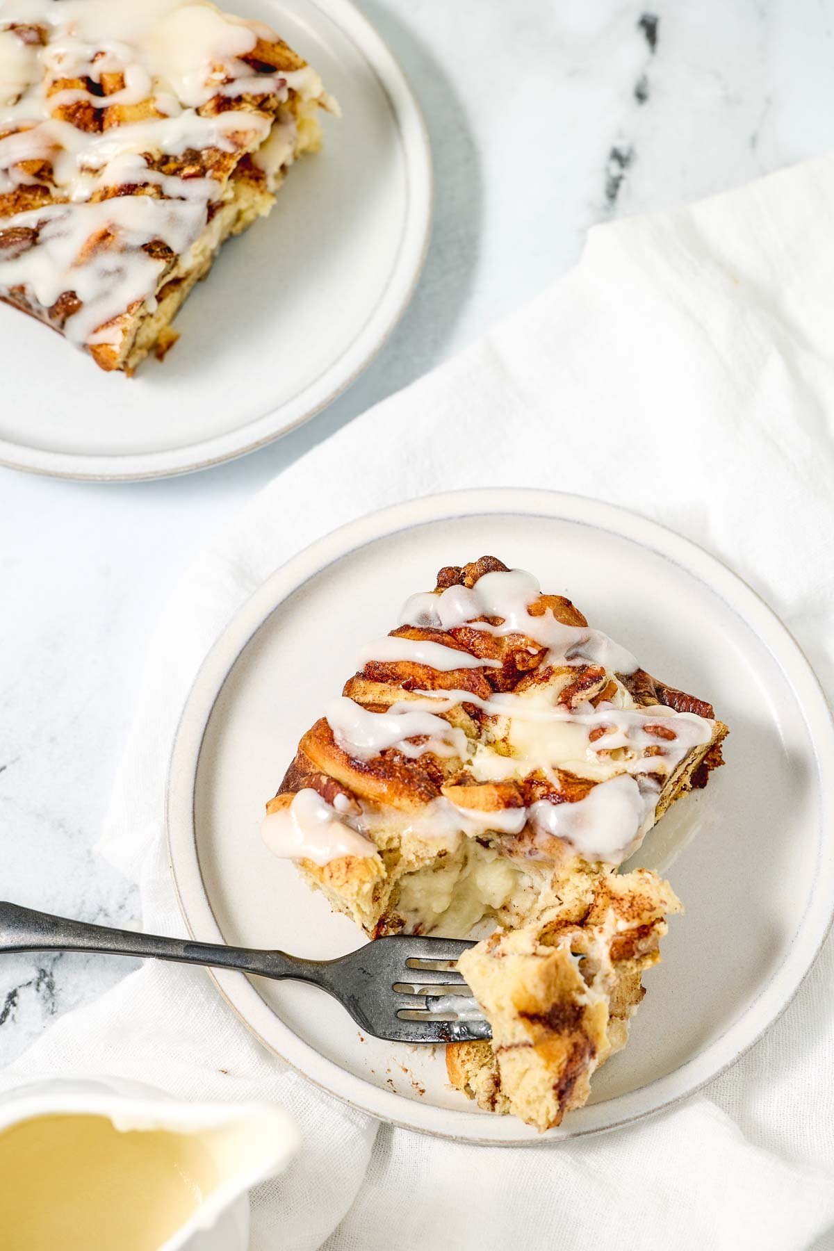 Cinnamon Roll Casserole aerial view on plates with fork.