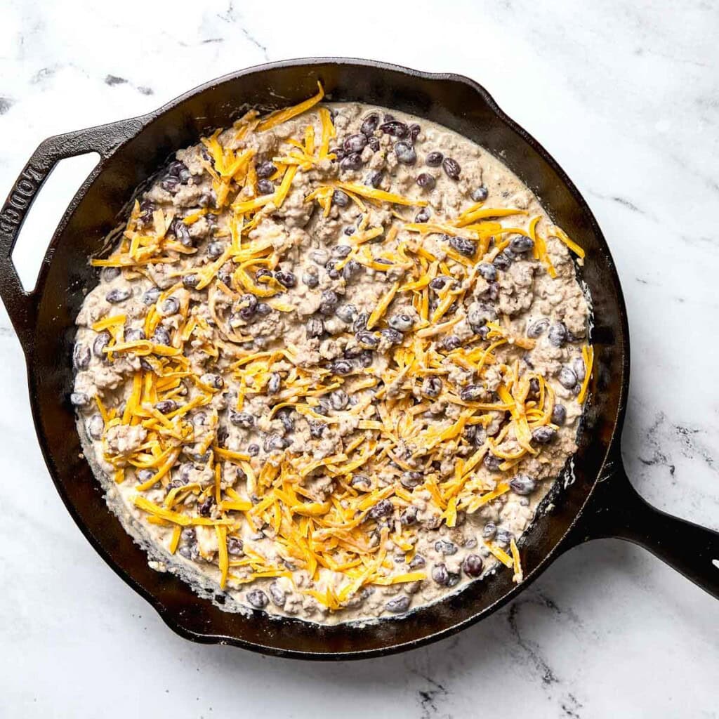 Cheddar stirred in to Cowboy Casserole recipe.