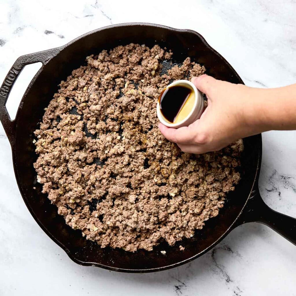 Adding Worcestershire sauce to Cowboy Casserole recipe.