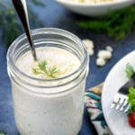 Feta Dressing in jar made with Greek yogurt, crumbled feta, and fresh dill.