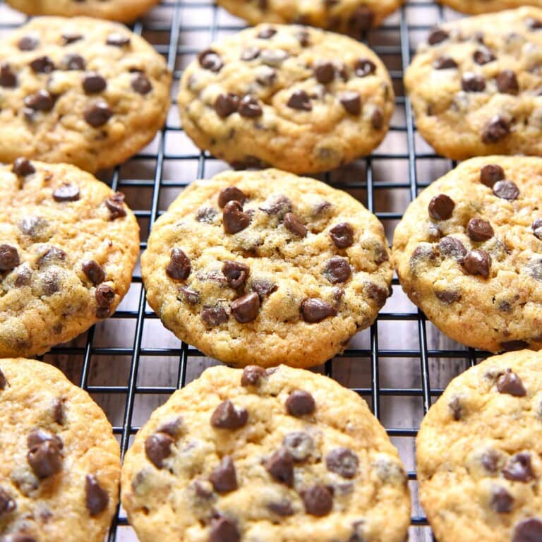 Whole Wheat Chocolate Chip Cookies lined up on cooling rack.
