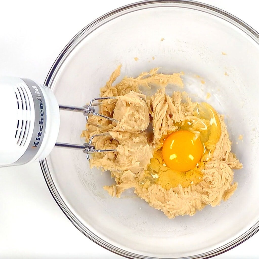 Adding egg to Whole Wheat Chocolate Chip Cookie recipe.