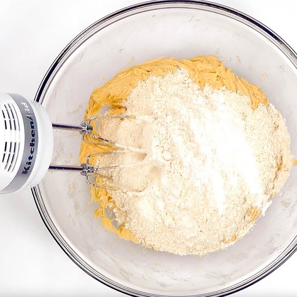 Adding dry ingredients to bowl.
